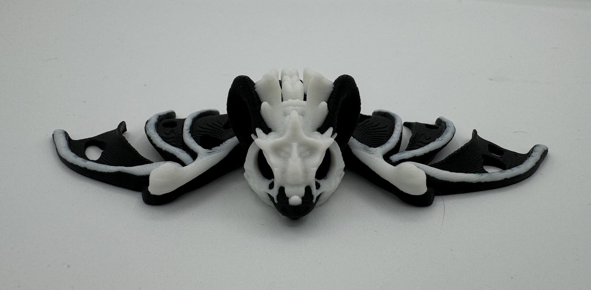 Articulating fidget “hollow bat” toy