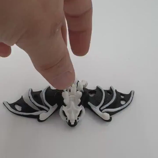 Articulating fidget “hollow bat” toy